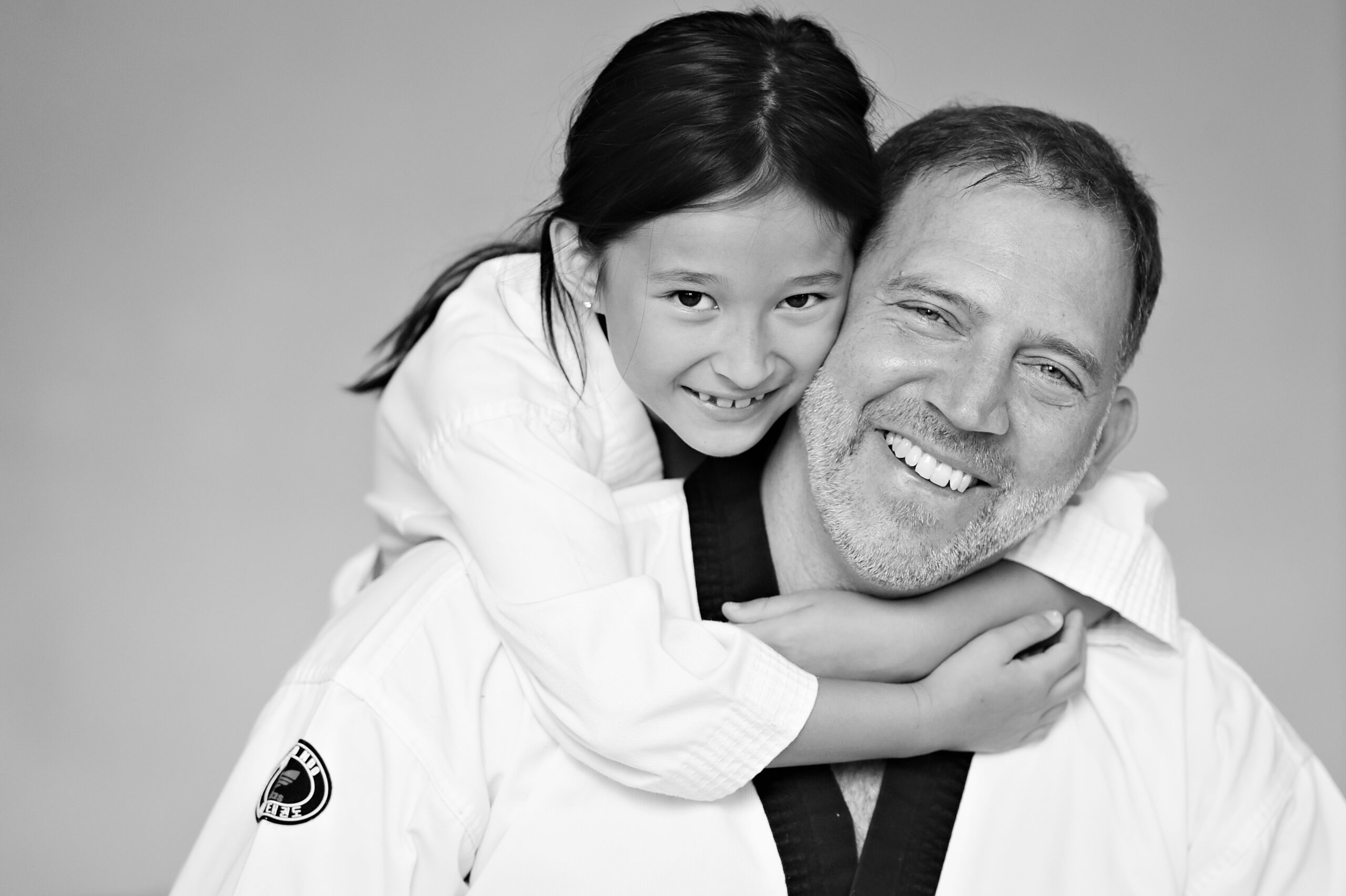 Dr. Salvatore Sandone smiling with a young martial arts student, reflecting confidence, trust, and mentorship.