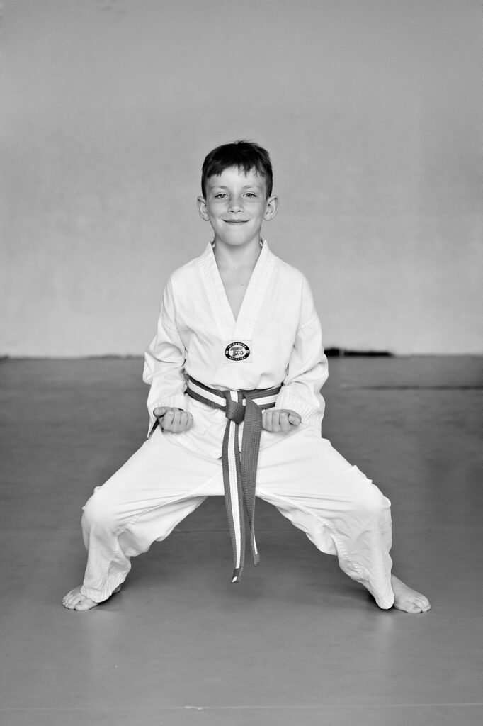 Young martial arts student performing Kiba Dachi horse stance