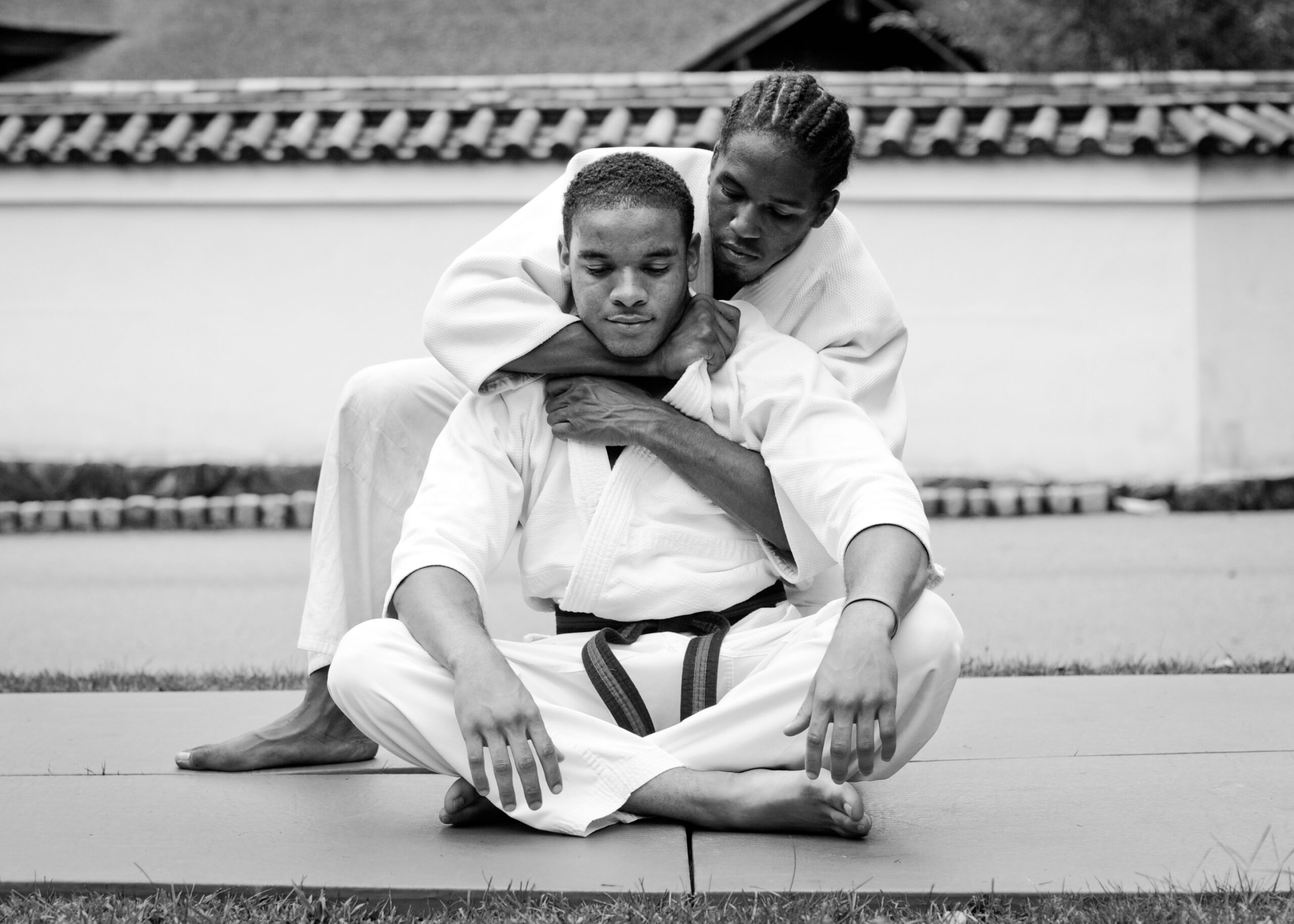 Two martial arts students demonstrating a grappling technique during training