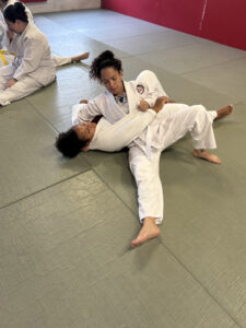 Two women practicing a ground technique in a women’s martial arts class at Zhang Sah